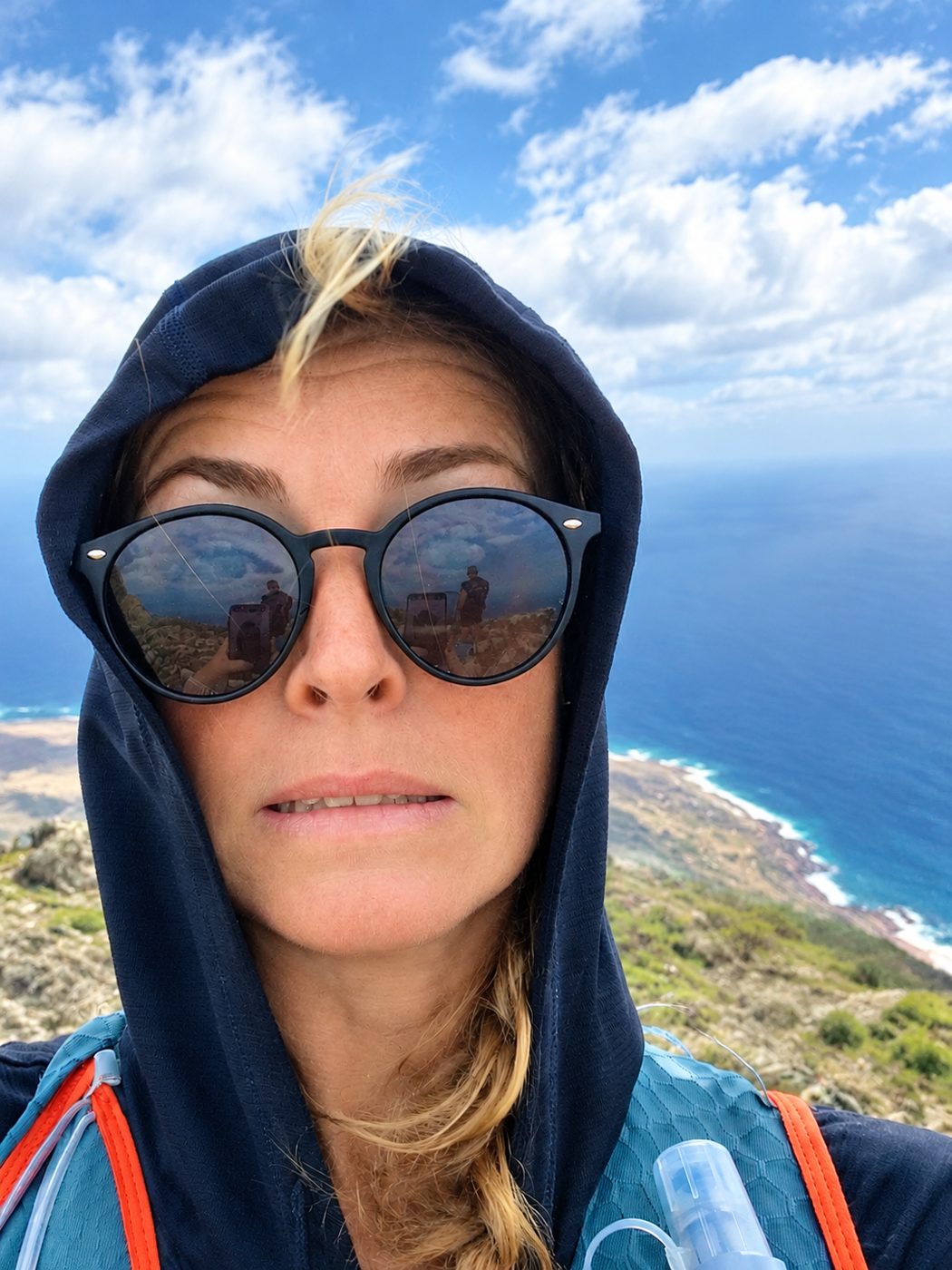 Freya Finch in a hood on a training walk above the Lanzarote coast